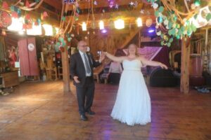 bridal couple in decorated Barn empty of looms