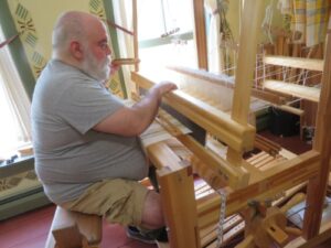 Joe weaving every bit of linen warp